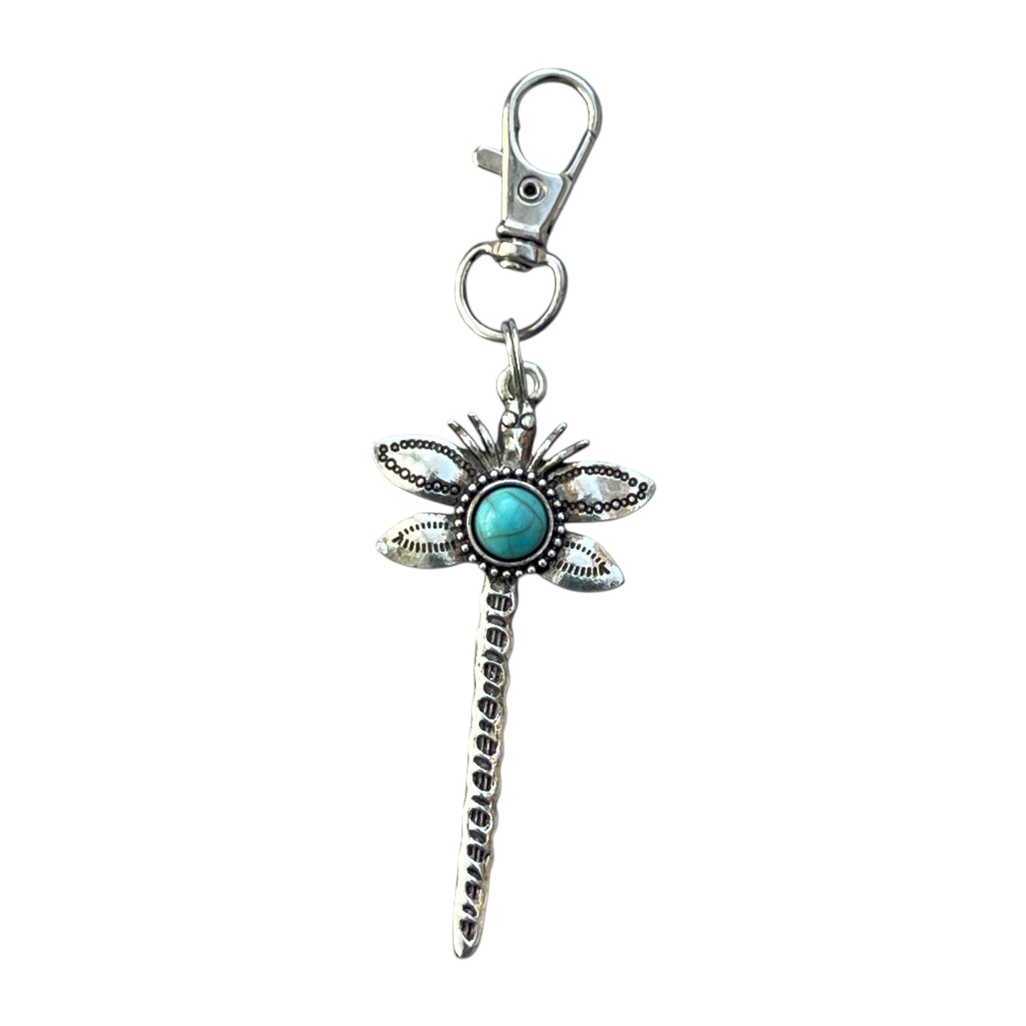 Dragonfly-shaped keychain with turquoise gem on a white background