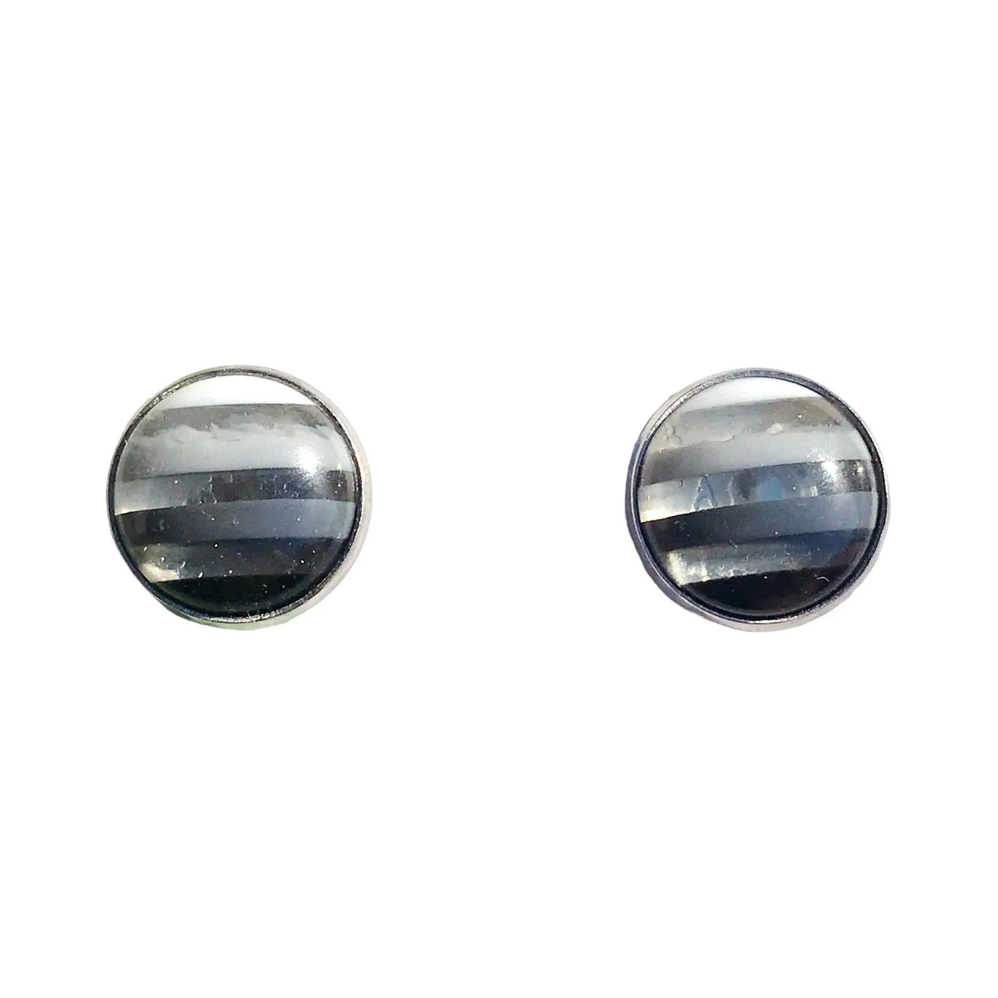 Silver bezel earrings laid flat on neutral background
