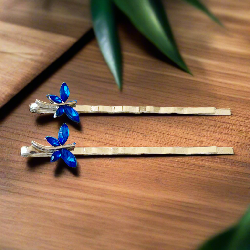 Set of two blue rhinestone dragonfly hair pins on white background
