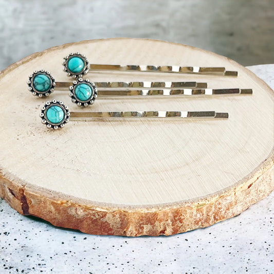 Close-up top view of boho hair pins with turquoise accents and silver-tone metal