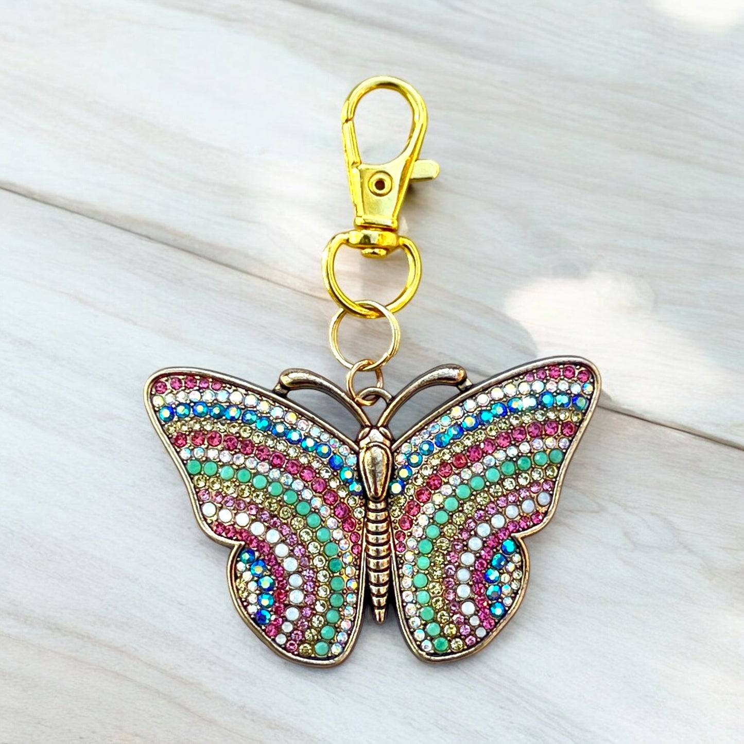 Handmade butterfly purse charm in pink, blue, green, and iridescent white