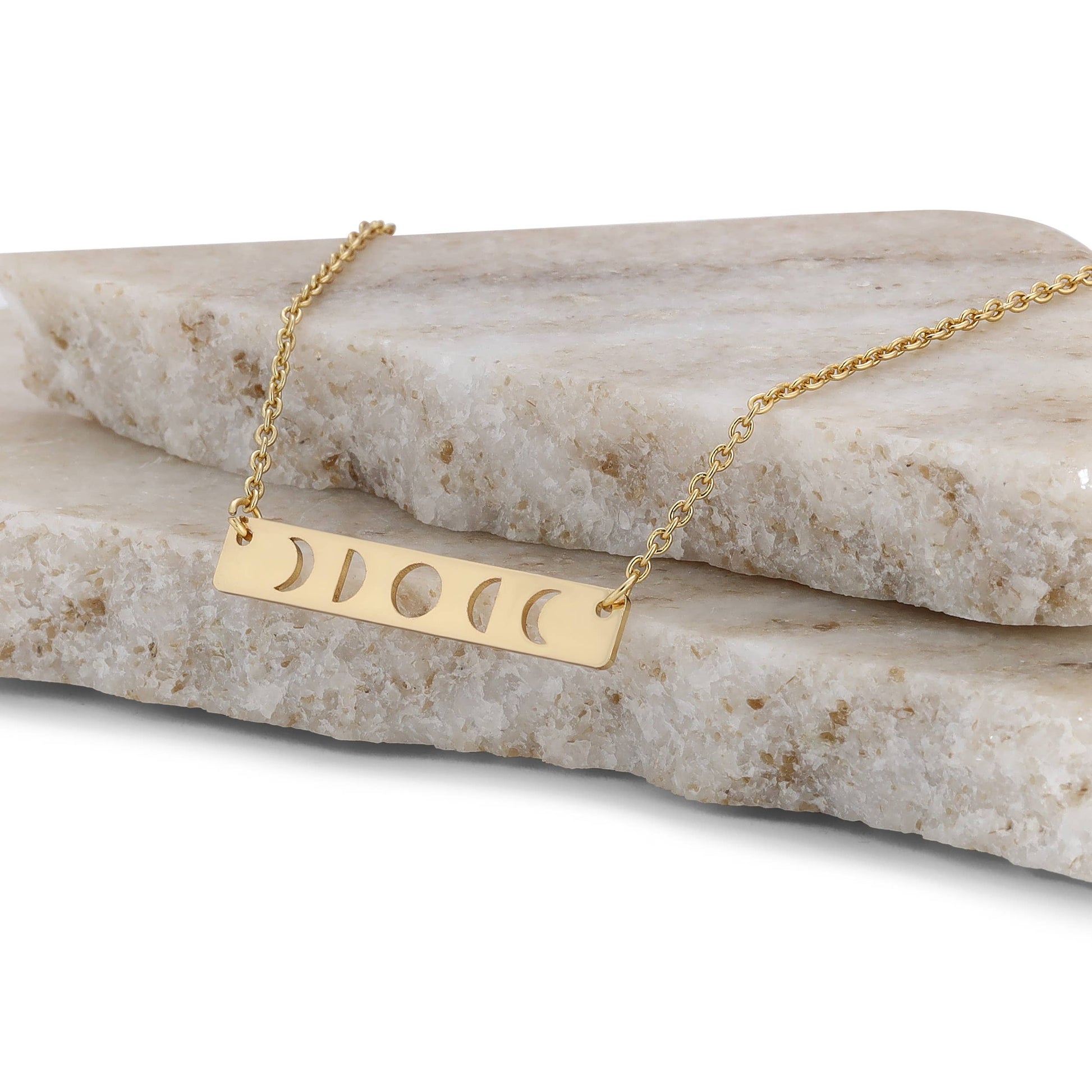 Curated gold moon phase necklace displayed in gift box with celestial vibe