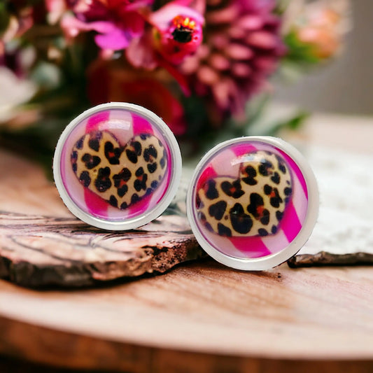 Close-up of handmade cheetah heart earrings showing glass cabochon detail