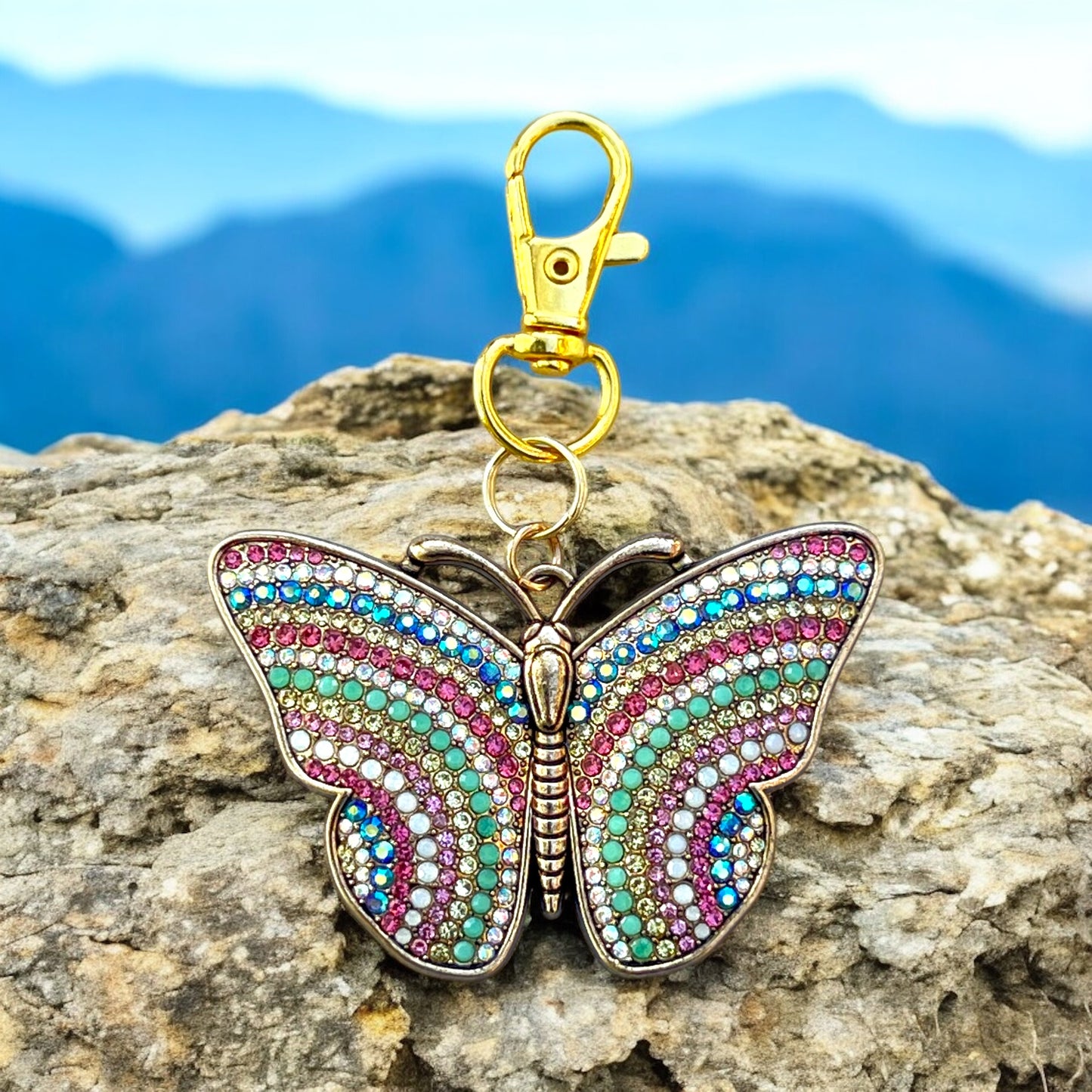 Close-up of colorful rhinestone butterfly keychain with gold metal finish