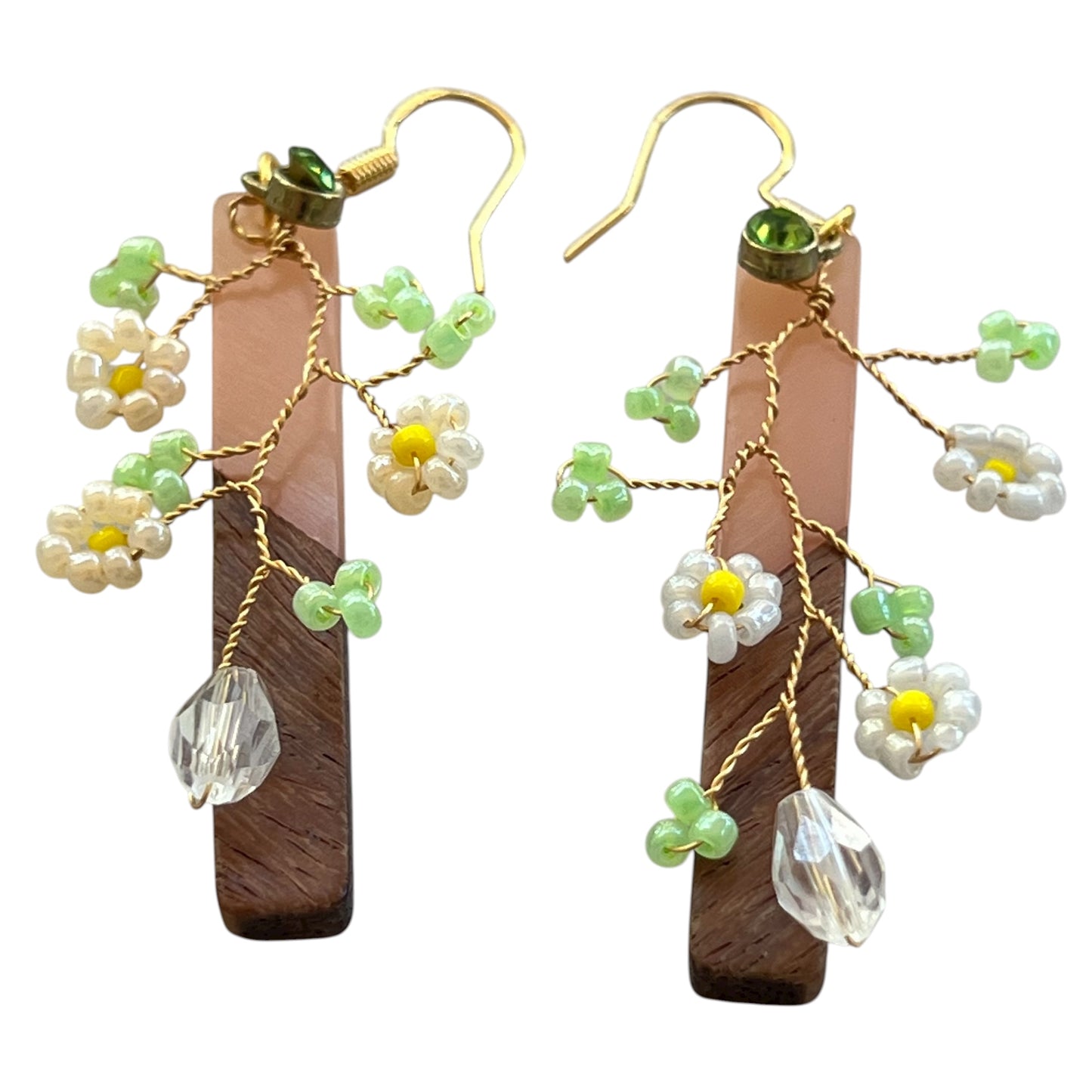 Pair of floral earrings with green and gold accents with wood bars.