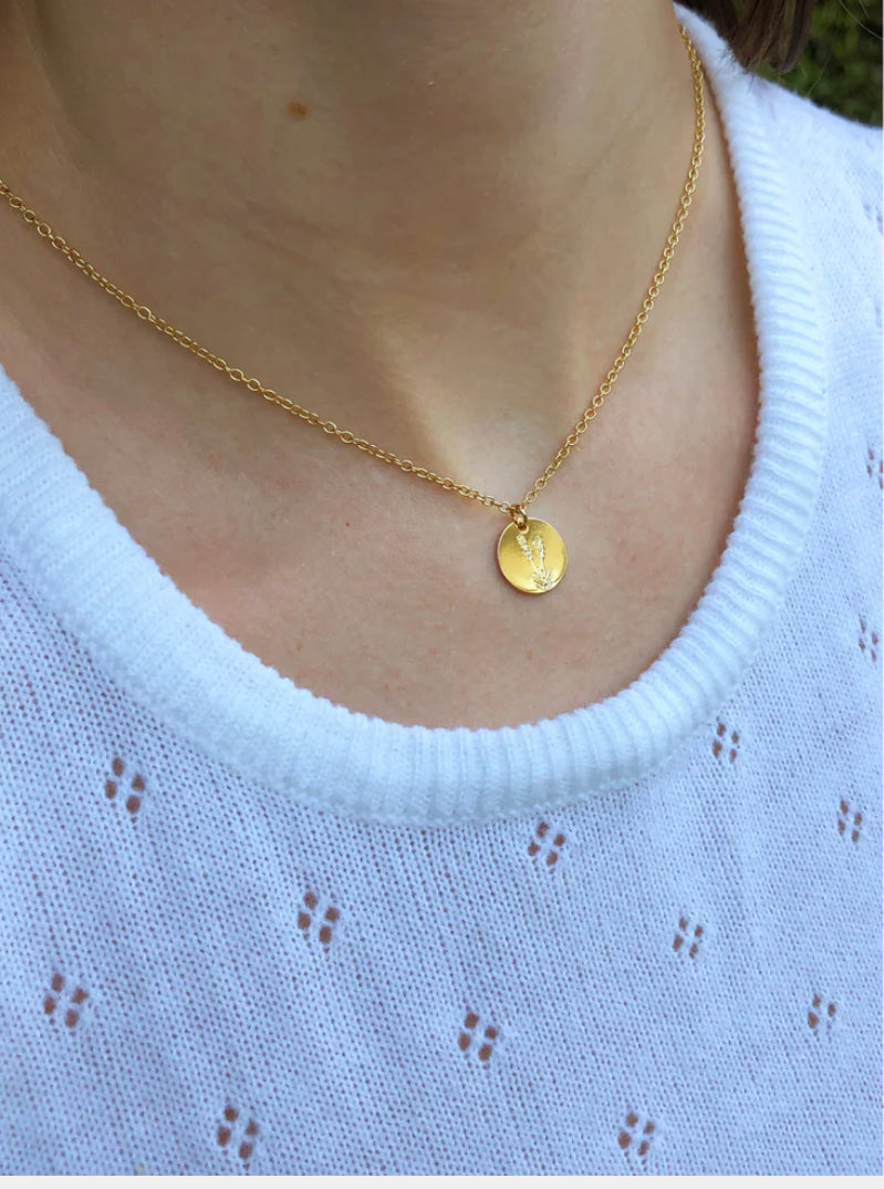 Botanical lavender necklace styled on model with minimalist outfit