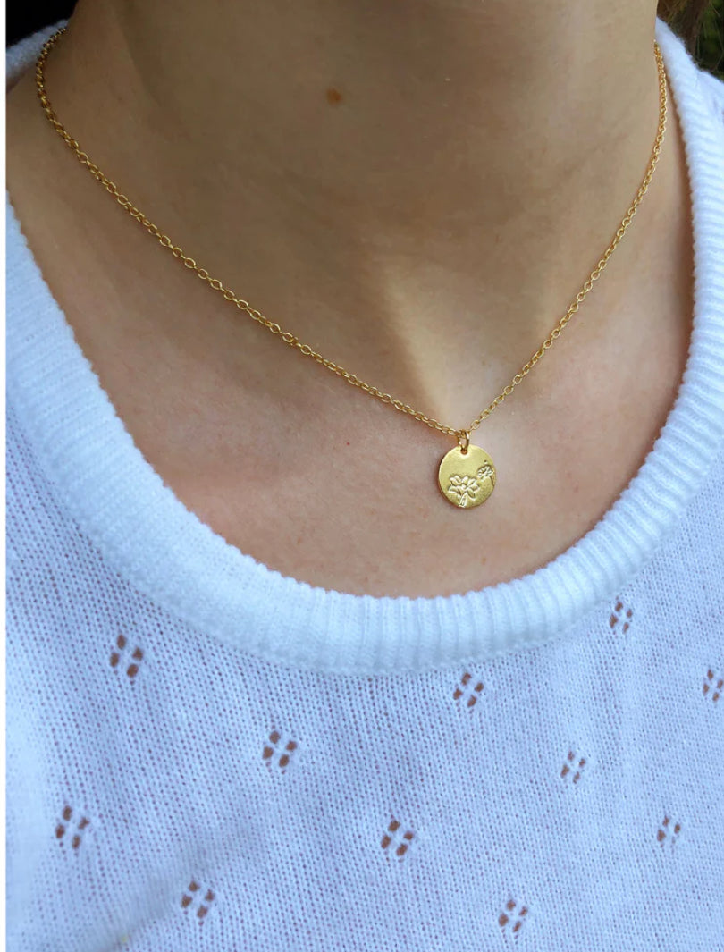 Lily pendant necklace worn on model with soft feminine style