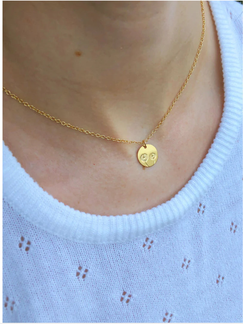Sunflower necklace worn by model with bright styling