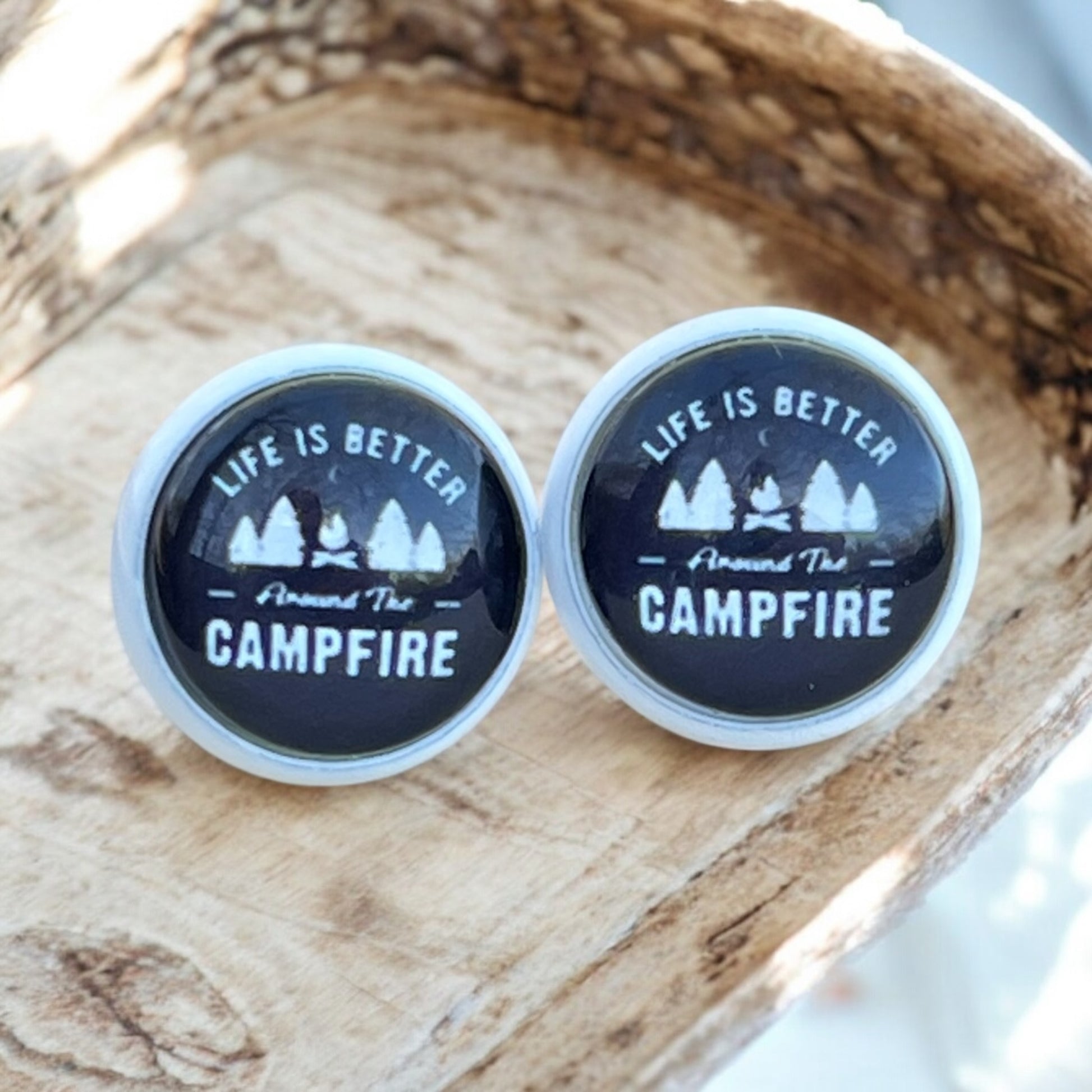 Handmade campfire stud earrings on wood-textured background