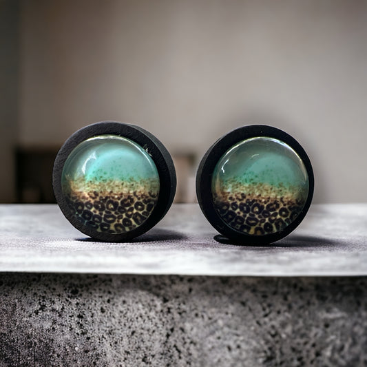 Mint Leopard Fade Resin Stud Earrings – Bold Handmade Boho Jewelry on a rock slat
