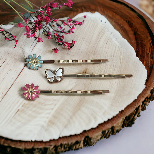 Set of 3 gold tone bobby pins with pink flower, mint flower, and white butterfly