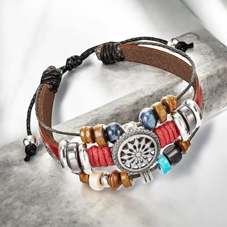 Flat lay of red boho wrap bracelet with faux leather and layered bead design