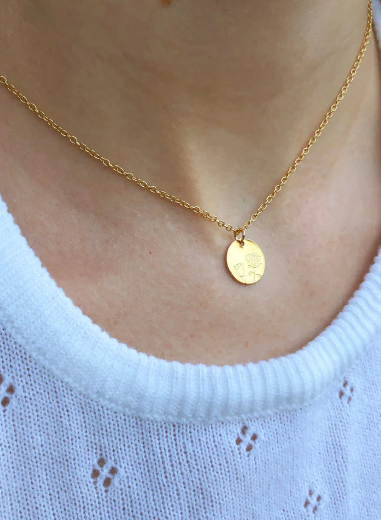 Botanical rose necklace worn on model with soft romantic styling