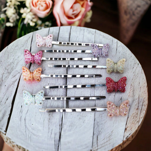 Close-up of silver bobby pins with delicate butterfly charms