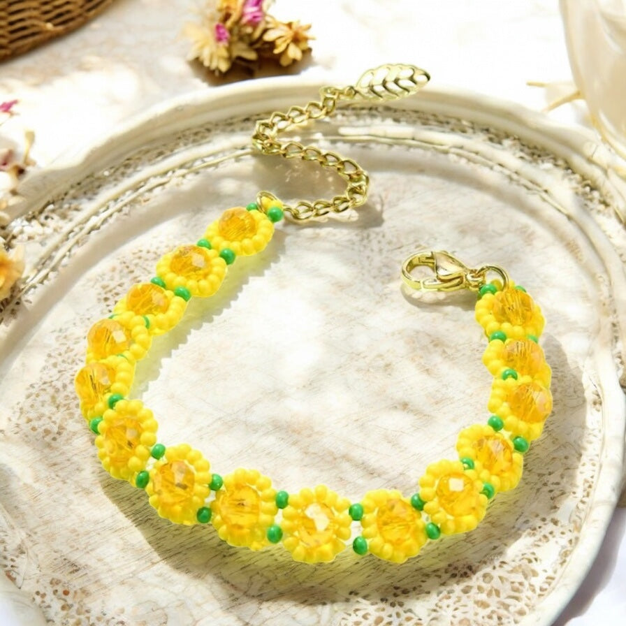Yellow sunflower bracelet stacked with other boho bracelets