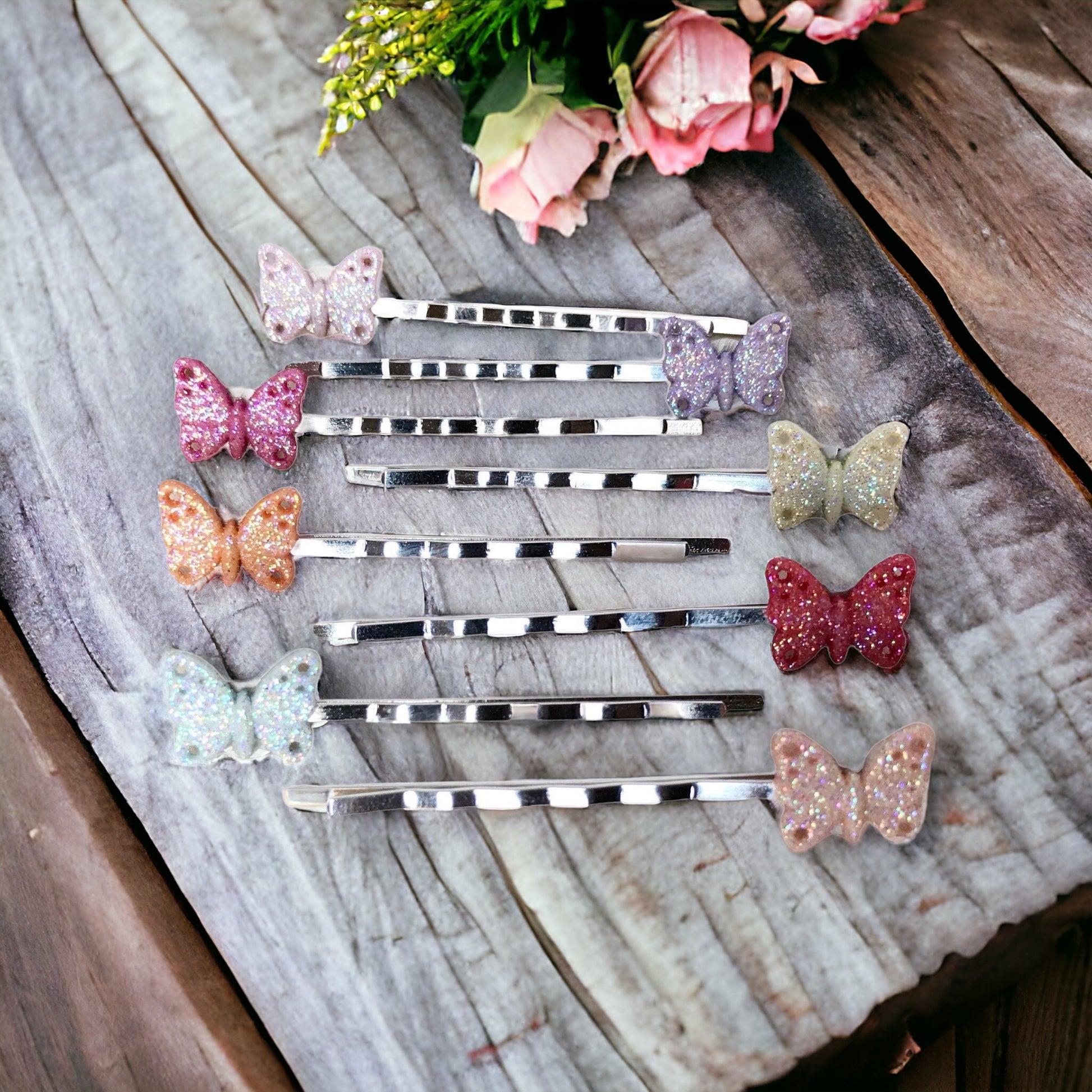 Set of 8 tiny gold butterfly hair pins displayed on white background