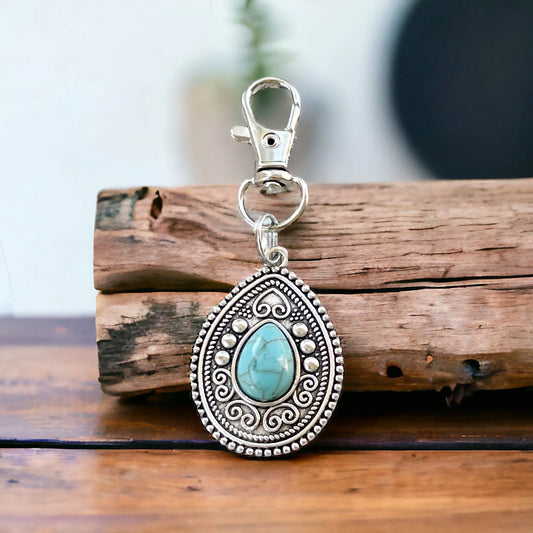 Turquoise Western Zipper Pull Handbag Keychain Charm - Stylish Western-Inspired Accessory on wood display