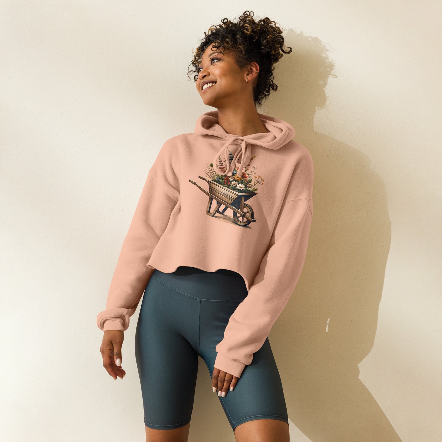Side view of peach boho crop hoodie with floral wheelbarrow design
