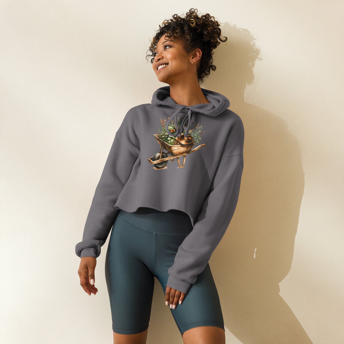 Model wearing storm gray crop hoodie with rustic garden theme