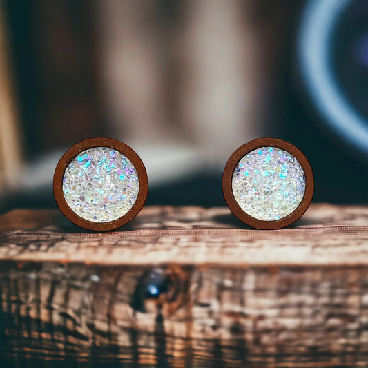 Round white glitter druzy wood stud earrings displayed on a rustic wood surface