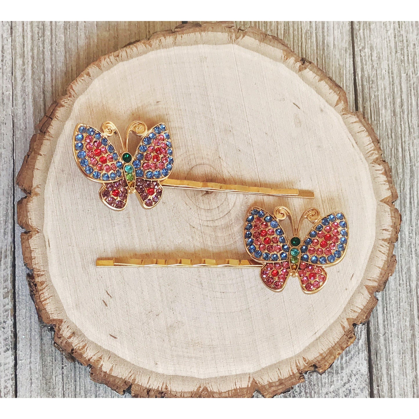 Sparkling butterfly hair pin with rainbow rhinestones in outdoor light