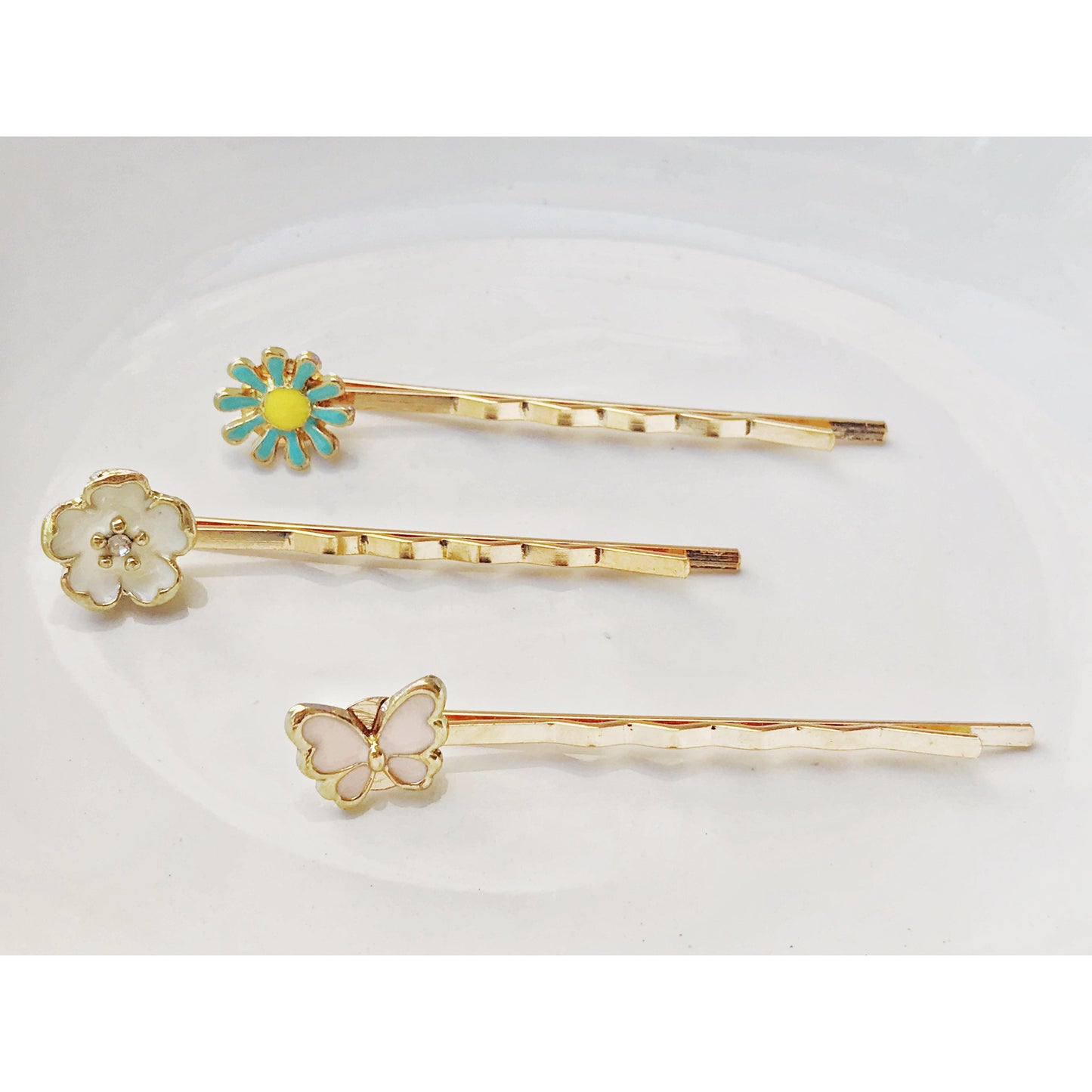 Dainty gold hair pins with butterfly and flower details