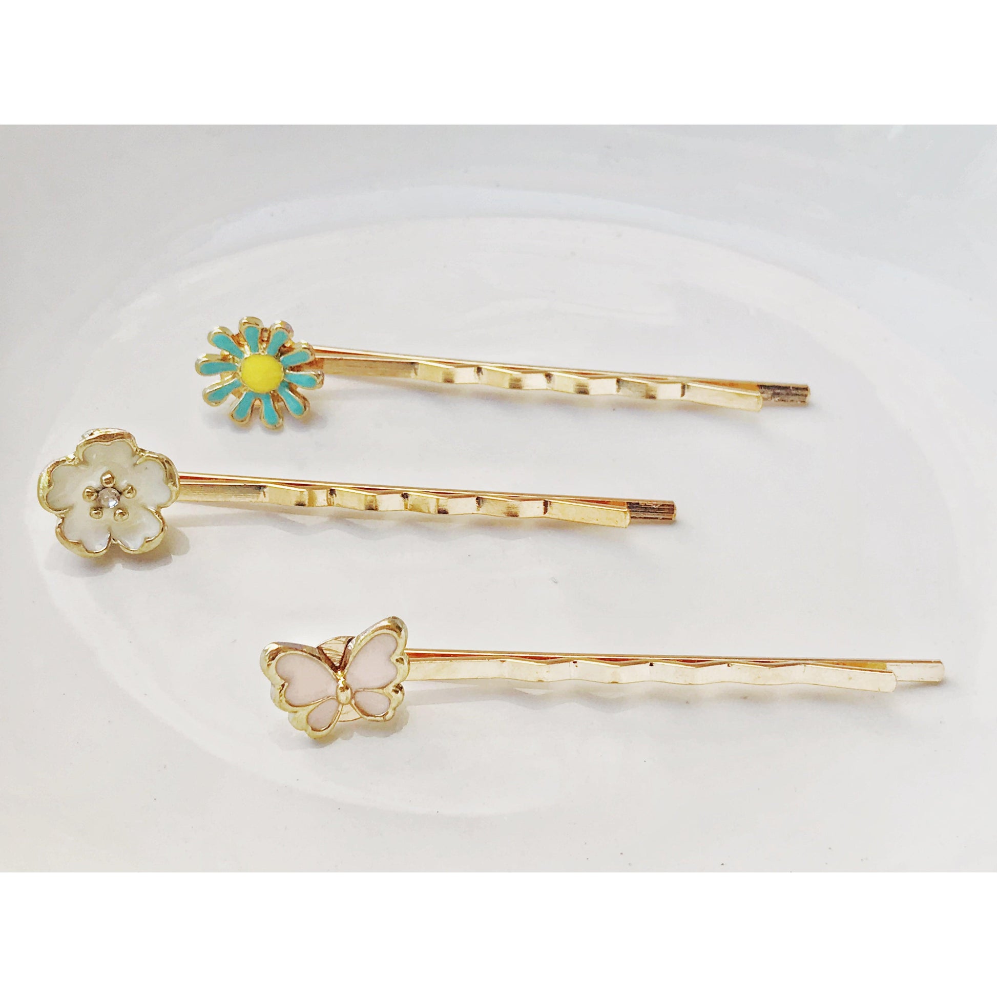 Dainty gold hair pins with butterfly and flower details