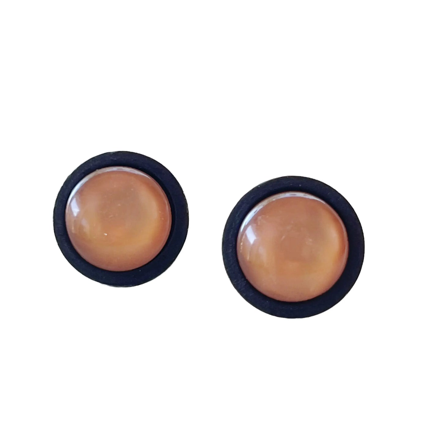 Round earrings with brown center and black border on a white background