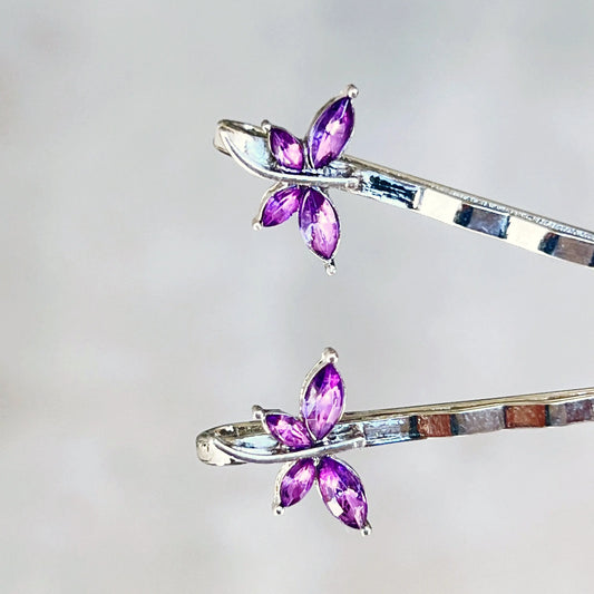 Close-up of handmade purple rhinestone dragonfly hair clips