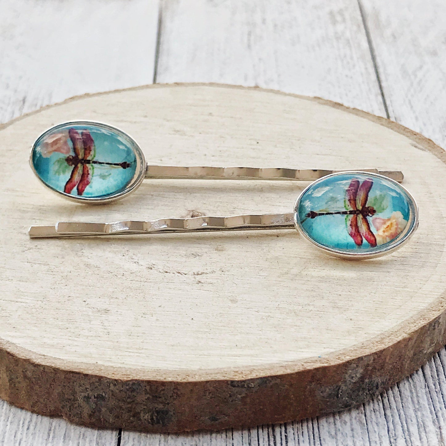 Close-up of gold dragonfly and flower embellishments on handmade hair pins