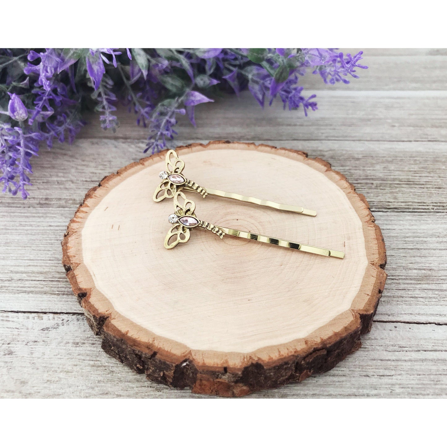 Gold dragonfly hair pins displayed on marble background for gifting