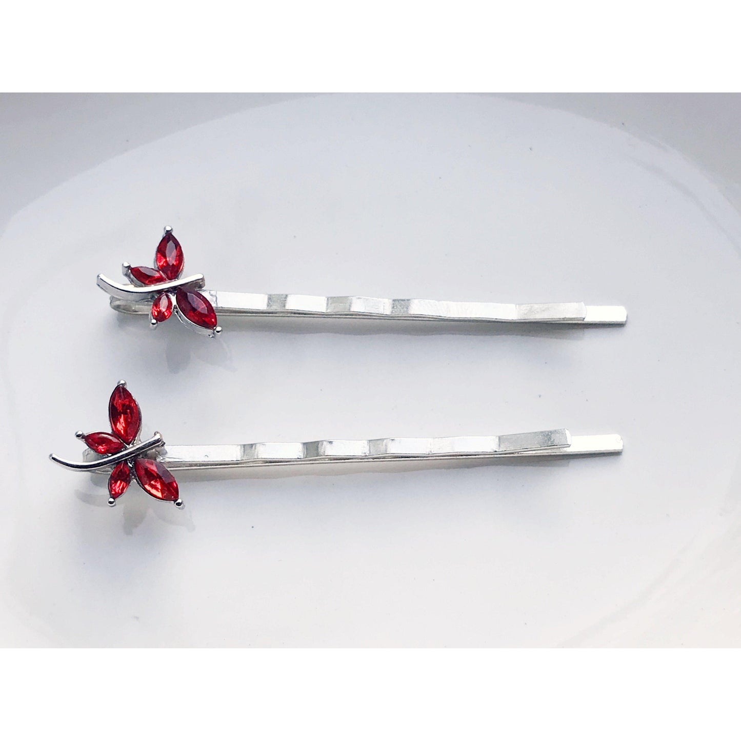 Delicate red dragonfly hair pins shown as giftable set