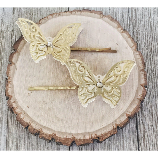 Close-up of filigree butterfly hair pins with rhinestone accents