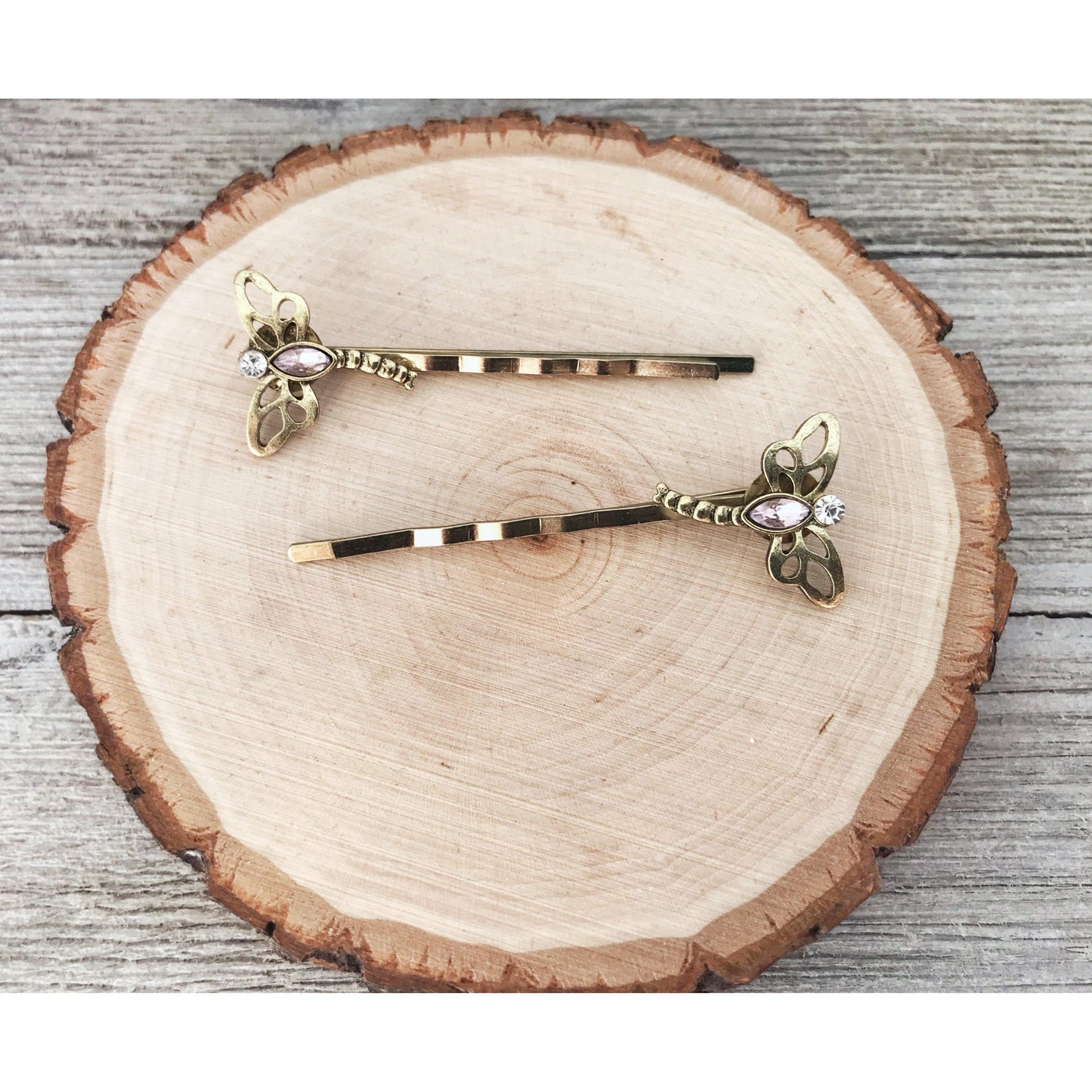 Dragonfly bobby pins with cutout wings and pink gem accent