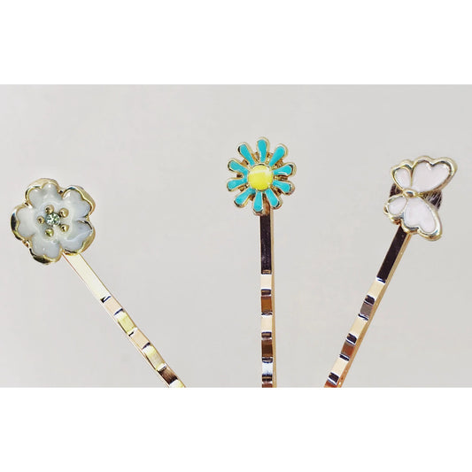 Close-up of pink and gold butterfly bobby pin