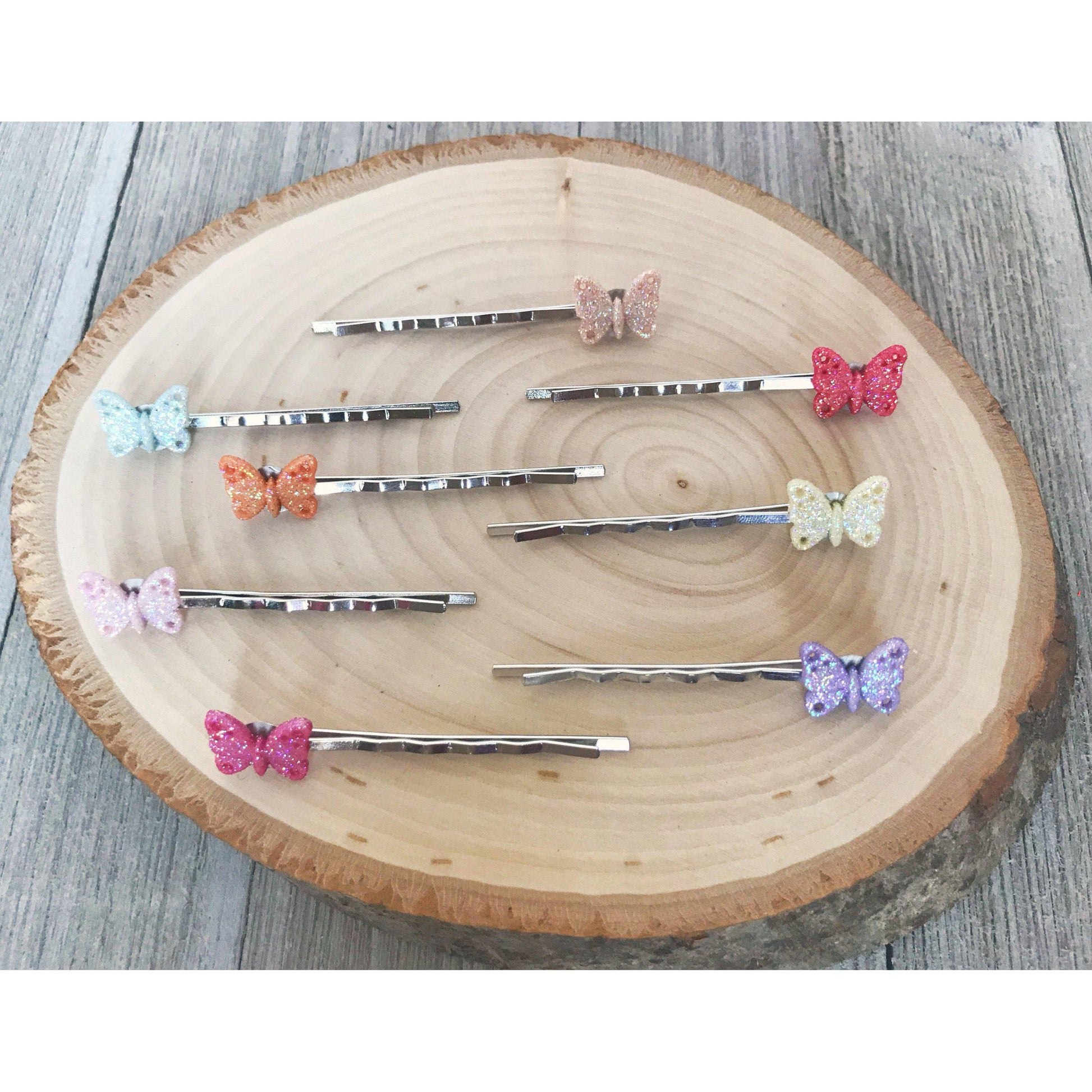 Styled flatlay of whimsical silver butterfly hair clips