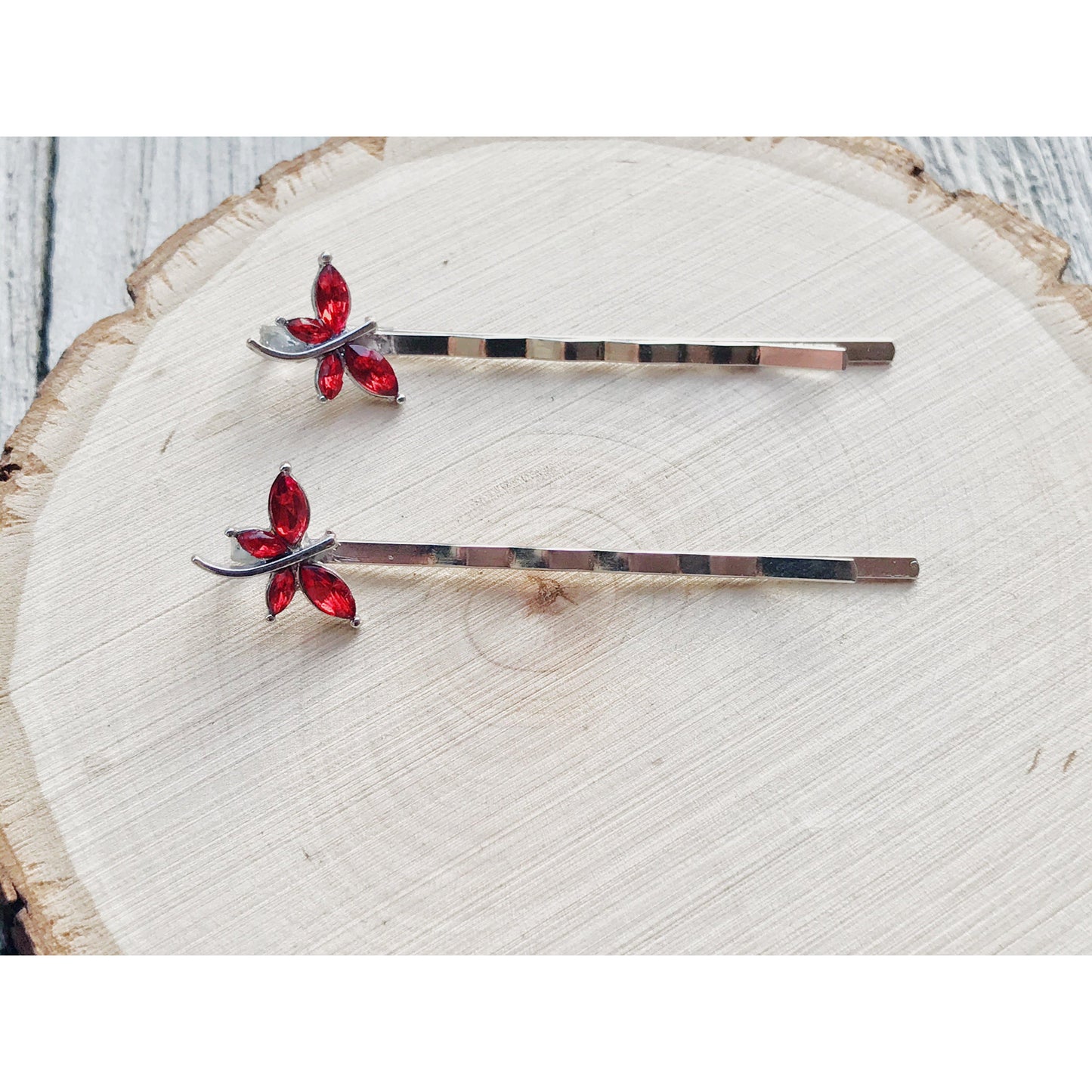 Side view of silver and red rhinestone dragonfly hair accessories