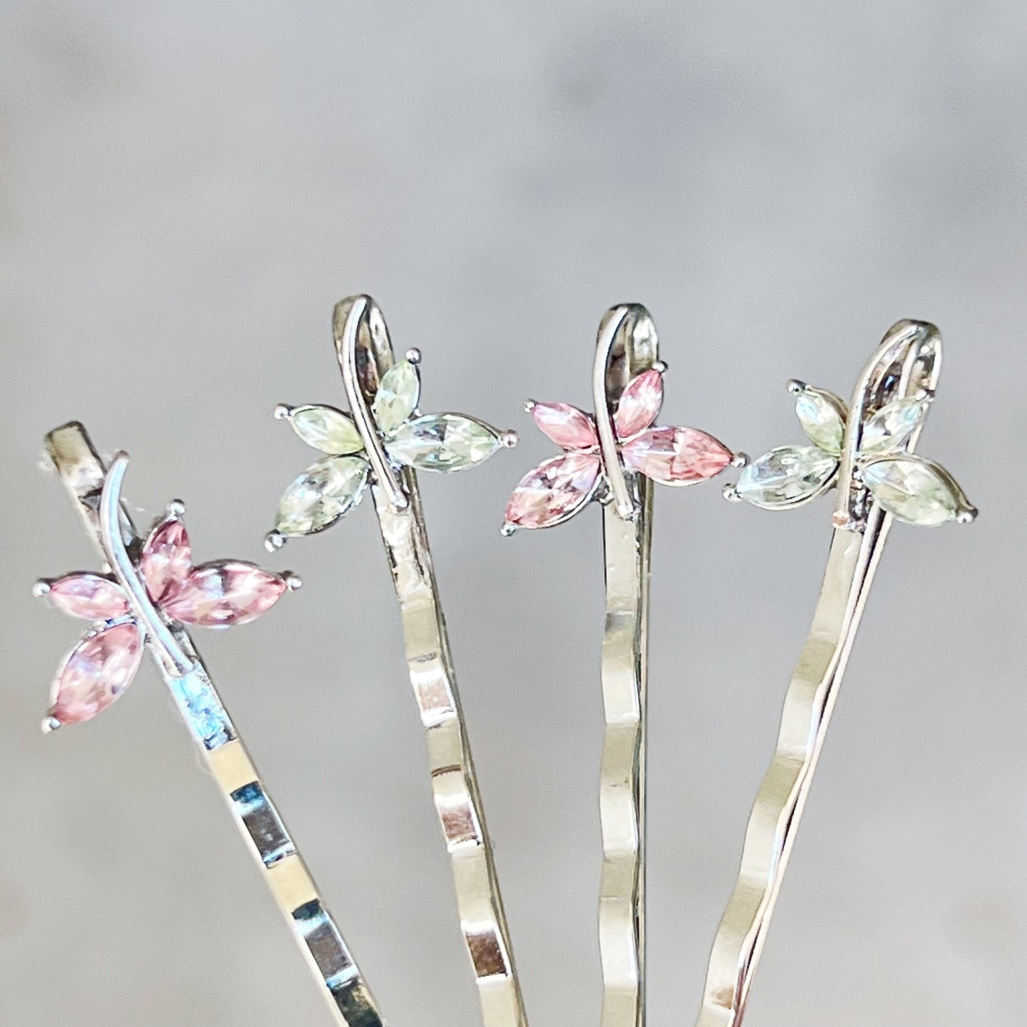 Delicate pink and green dragonfly hair pins for feminine styling