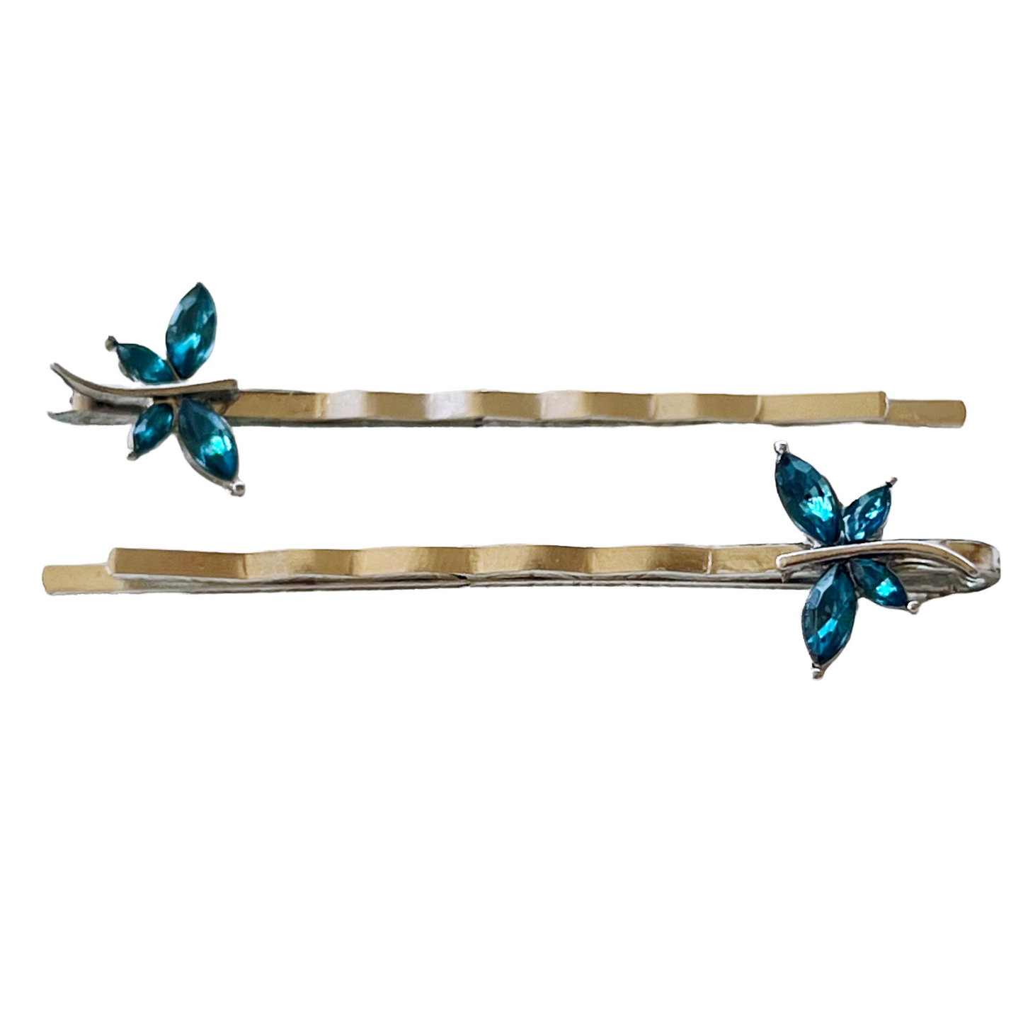 Photo of teal dragonfly hair pins on white background