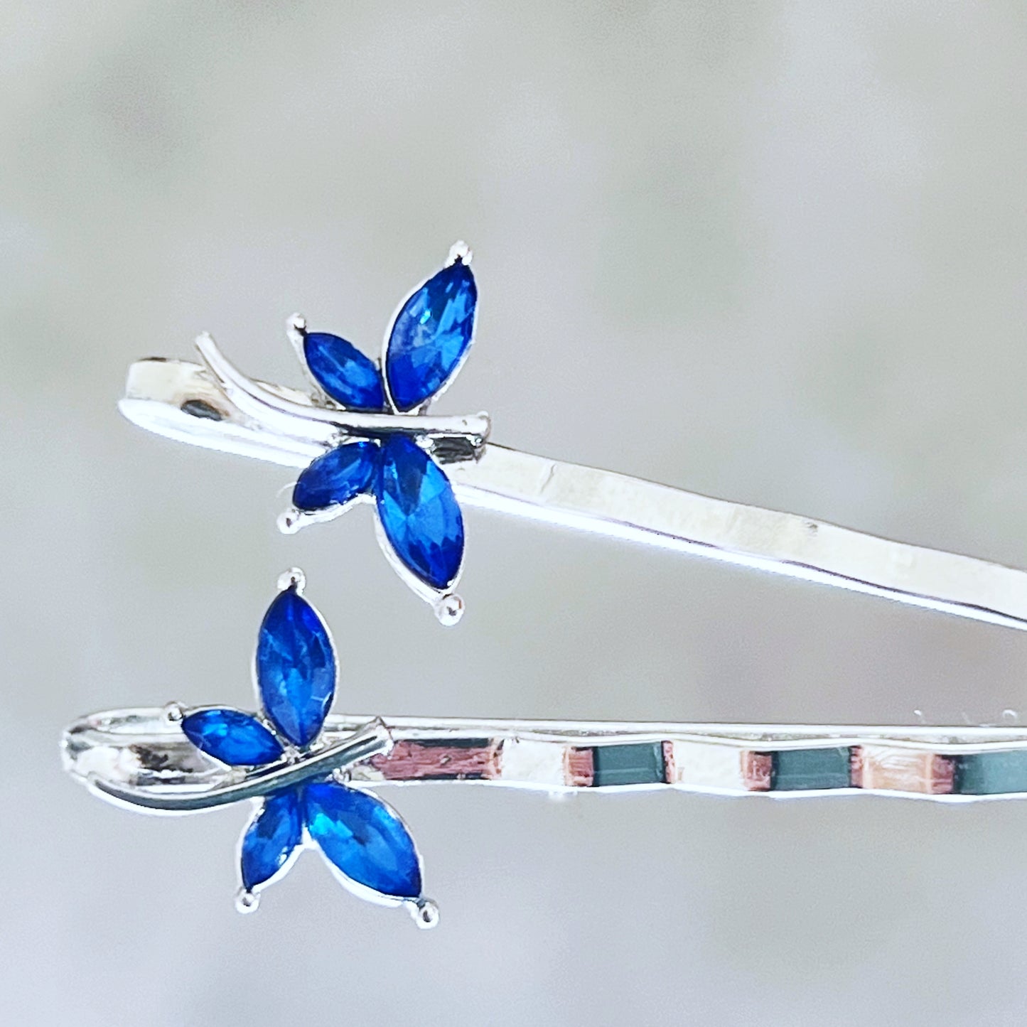 Size photo of tiny dragonfly hair pins with approximate 0.5 inch width