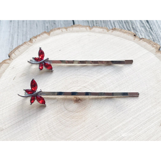 Close-up of red rhinestone dragonfly design on silver-toned hair pin