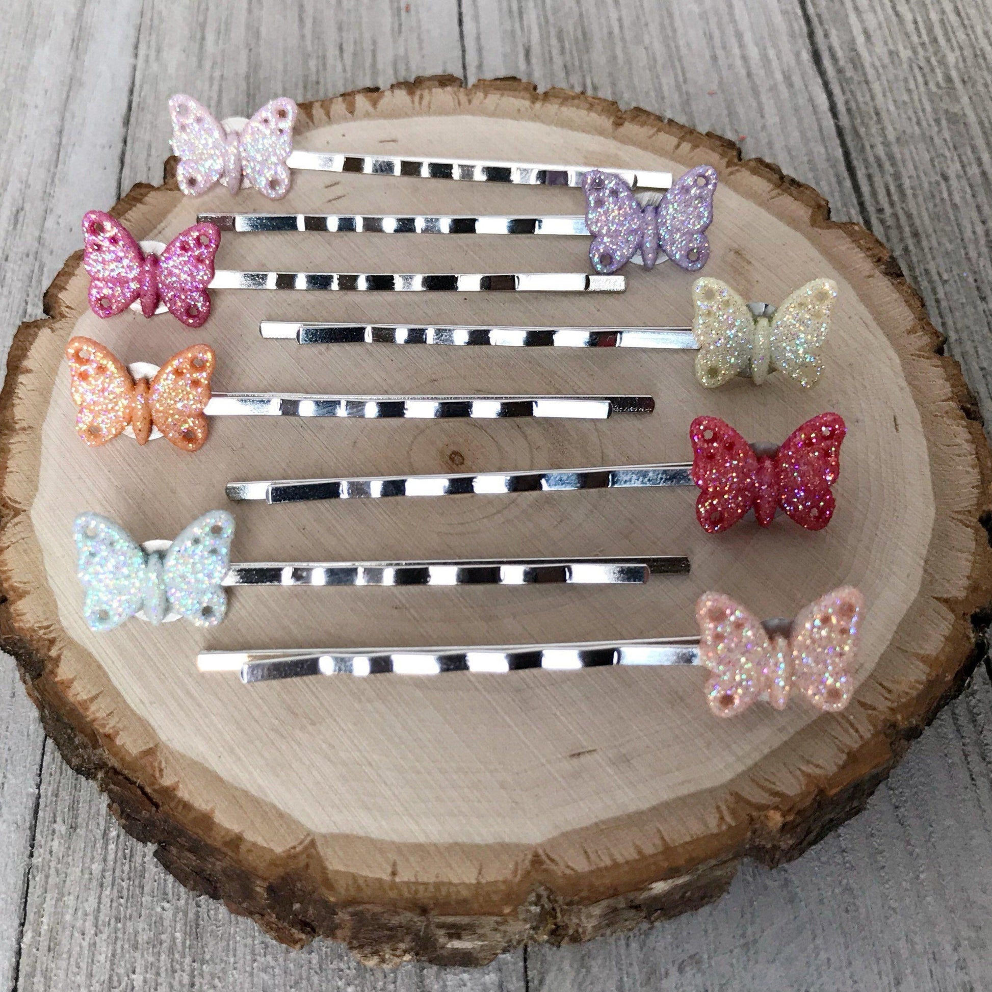 Lightweight silver butterfly hair pins laid out in group of eight