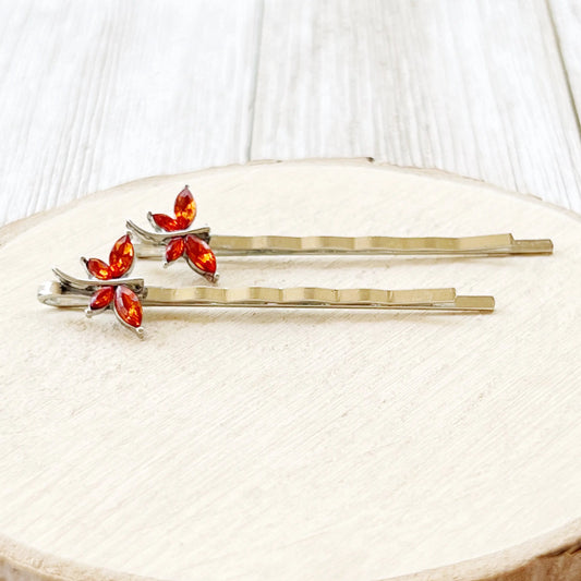 Whimsical orange dragonfly hair pin set styled for gifting