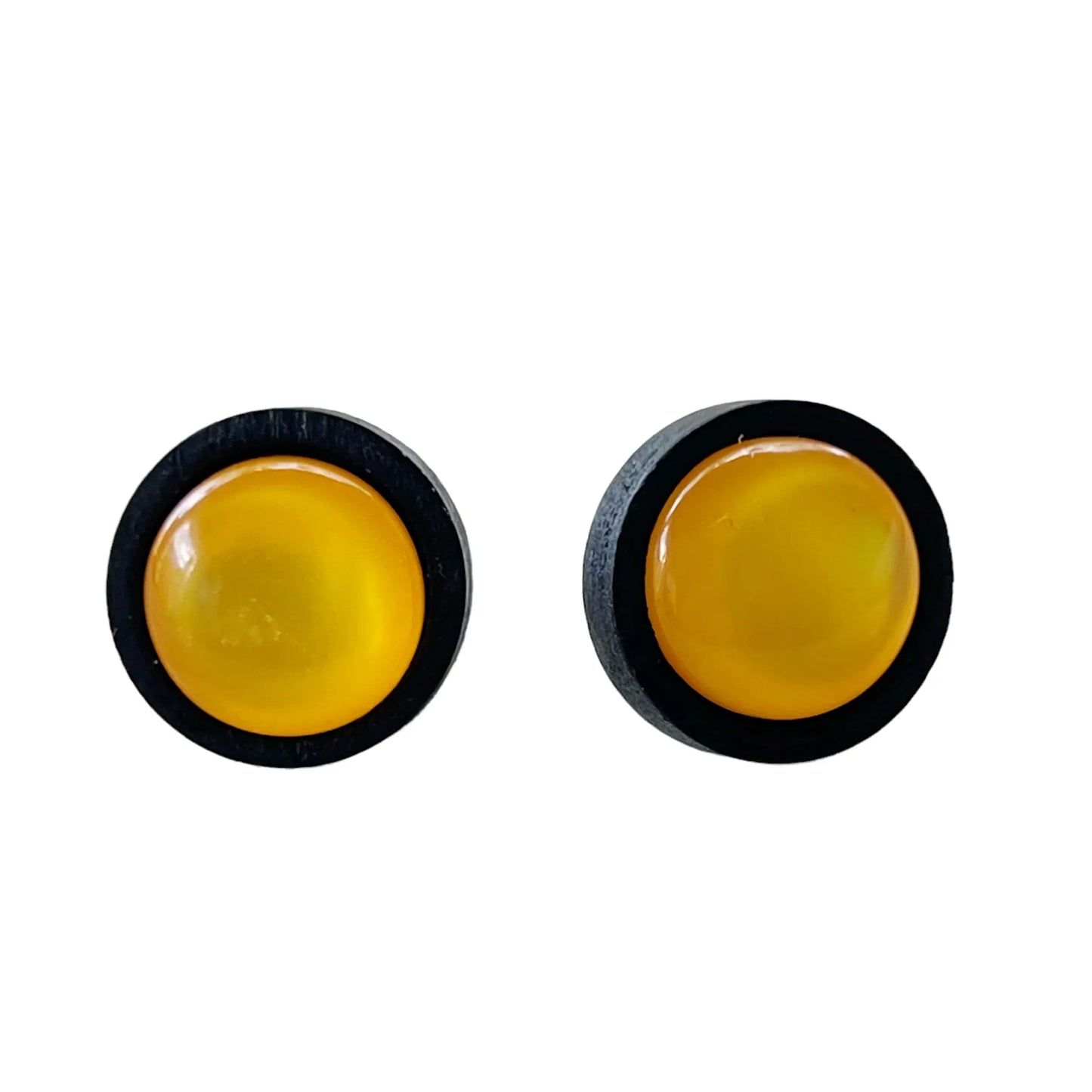 Pair of round yellow objects with black borders on a white background