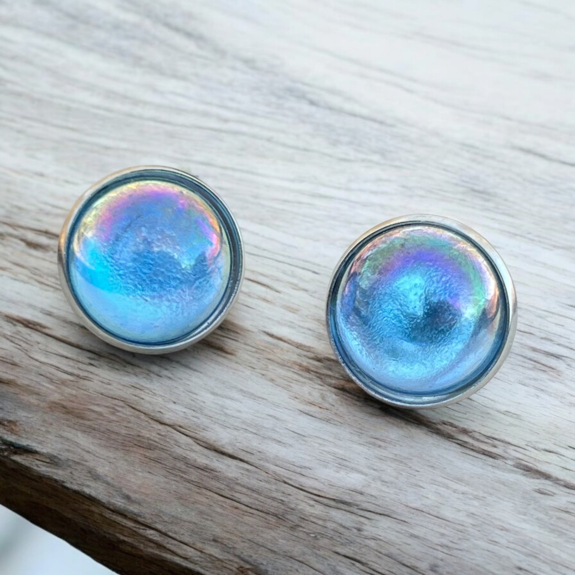 Close-up of 14mm iridescent earrings with silver bezel
