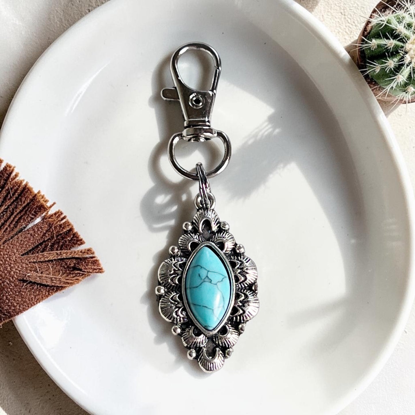 Charm para bolso con tirador de cremallera y color turquesa occidental