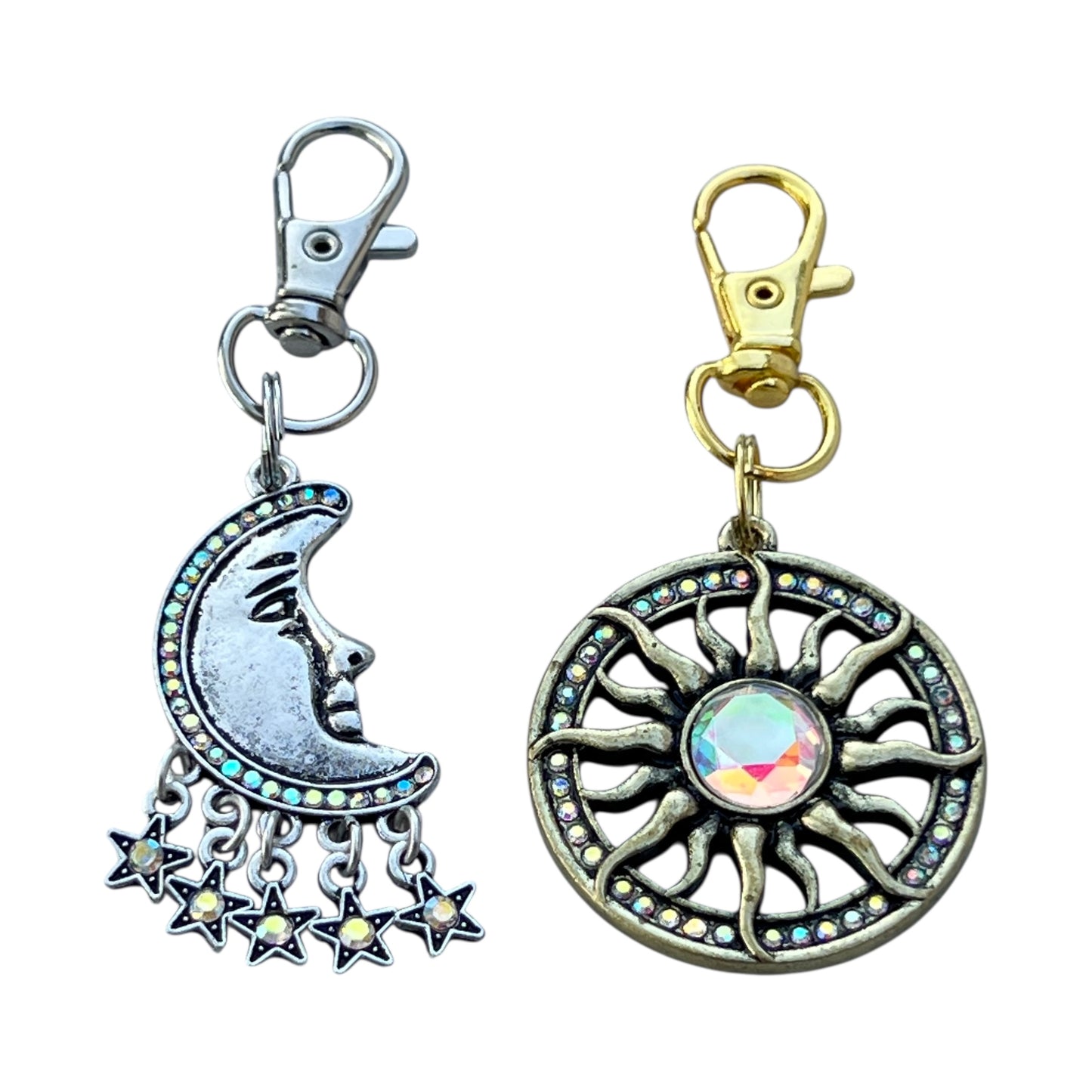 Two keychains, one with a moon and star design and the other with a sun and circular pattern, on a white background.