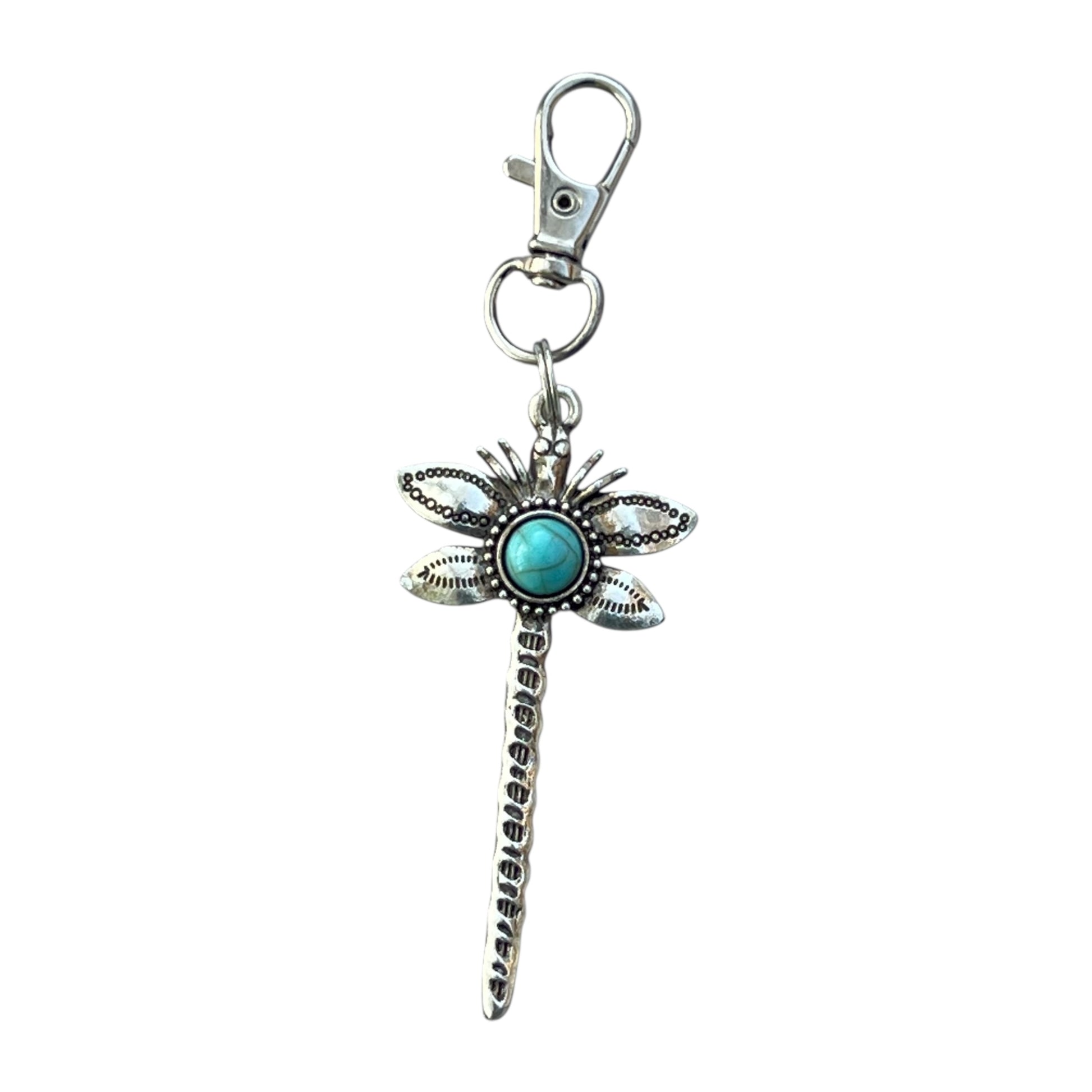 Dragonfly-shaped keychain with turquoise gem on a white background