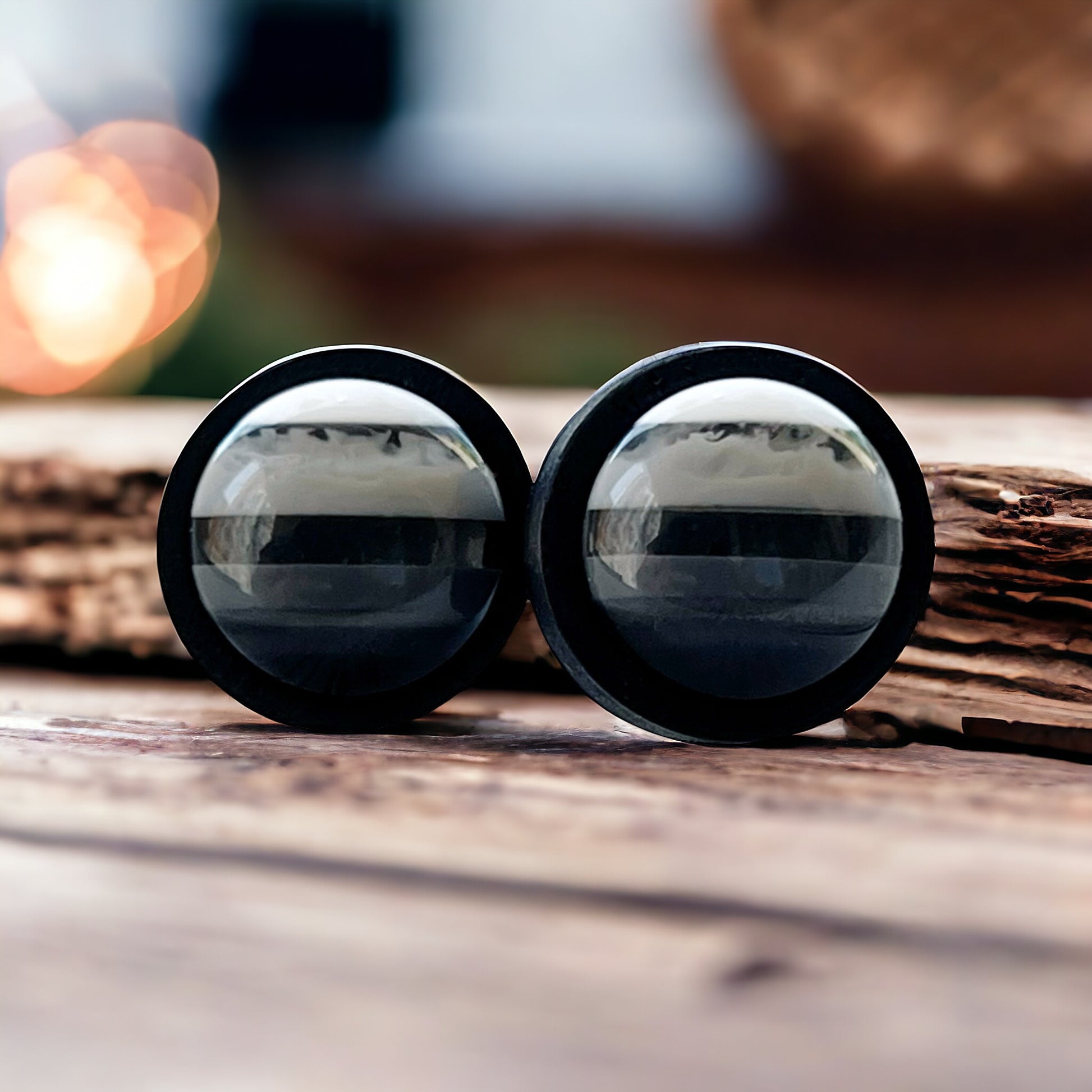 Close up of stud earrings outdoors with reflection