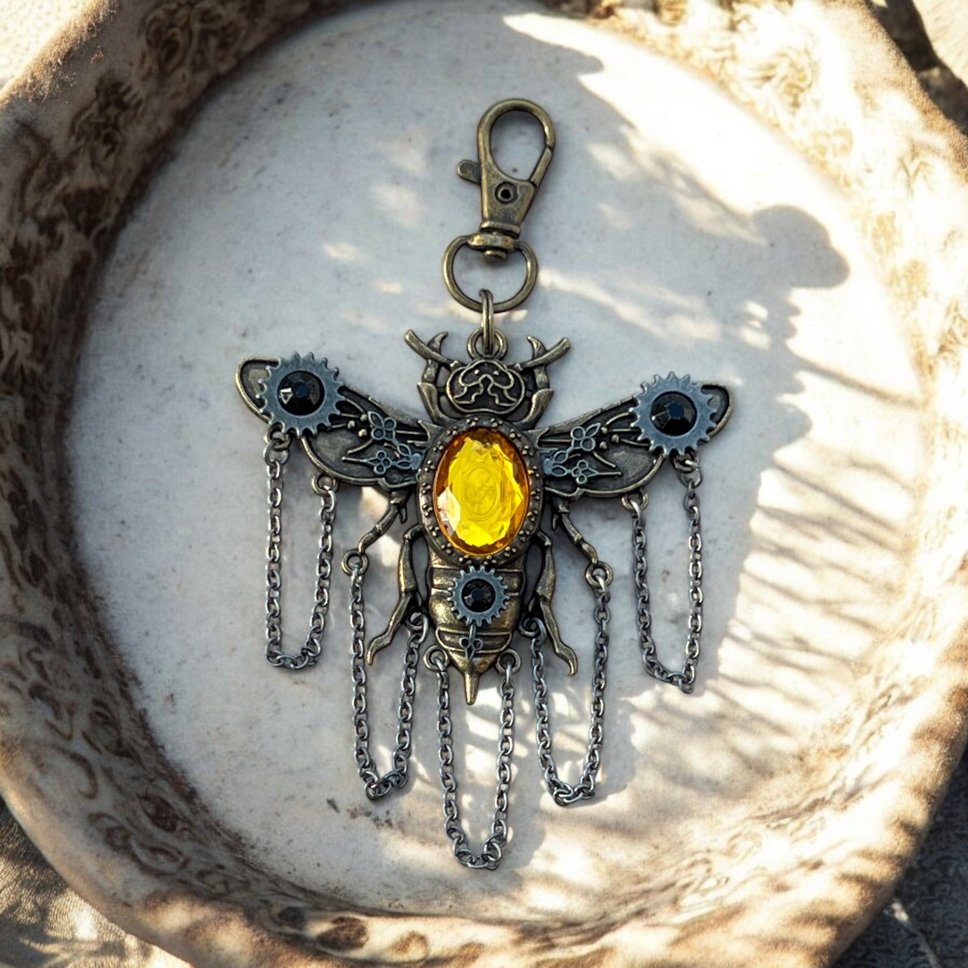 Steampunk insect purse charm in palm for scale